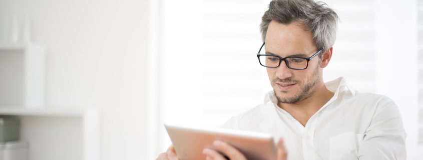 handsome man surfing on tablet